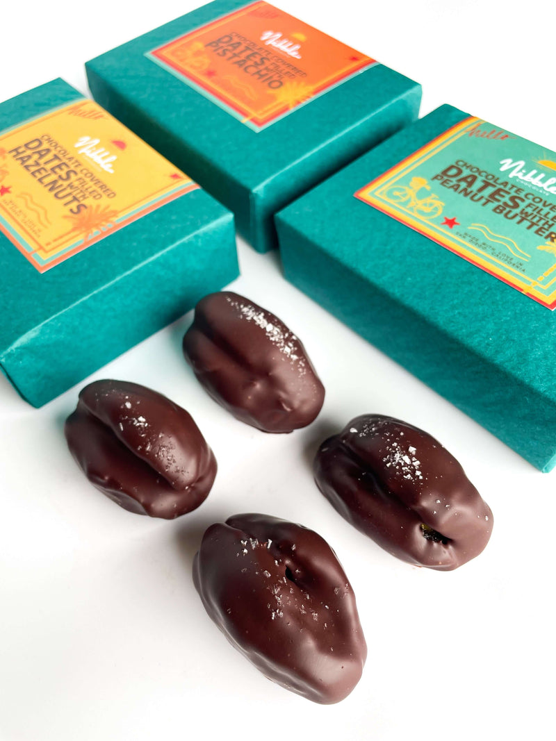 Open green gift box with dark chocolate-covered dates, Nibble Chocolate