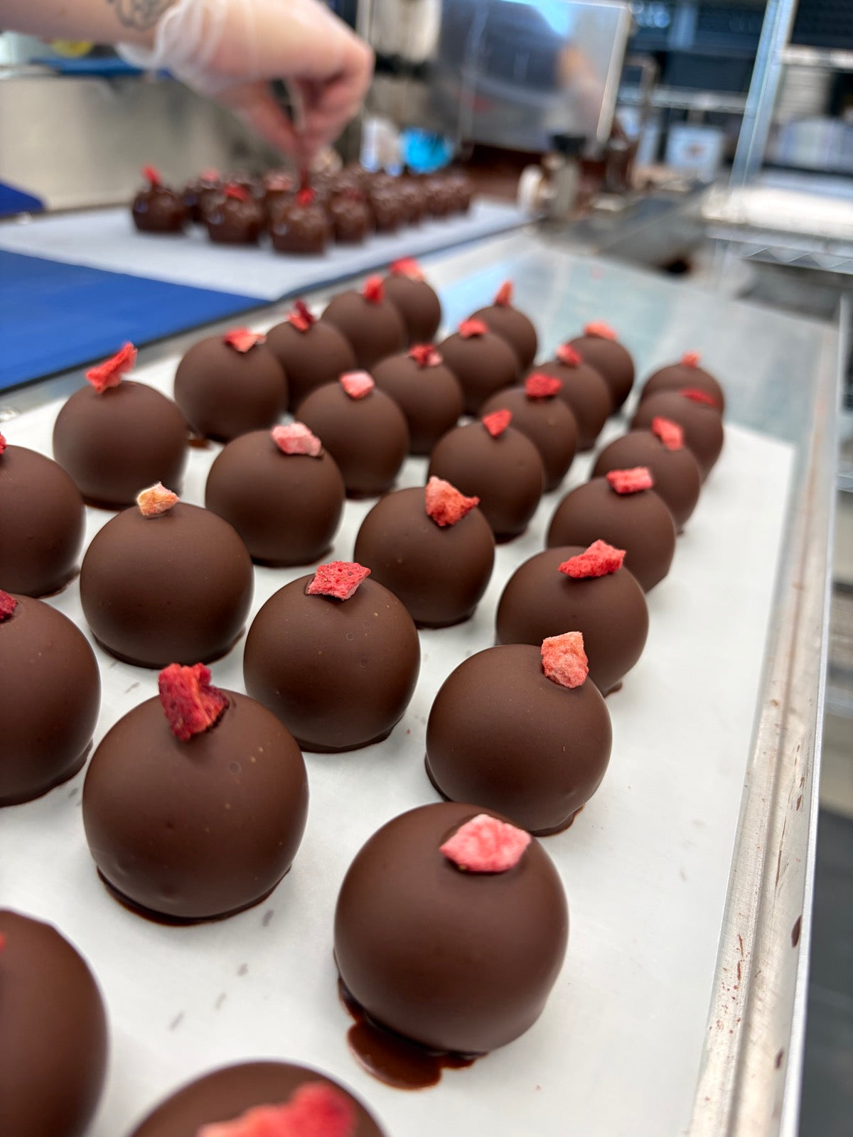 Chocolate truffles topped with strawberry pieces